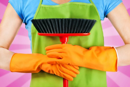 Professional carpet cleaner applying treatment to a carpeted floor